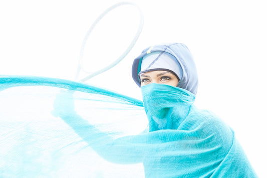 woman with green cover in her face standing