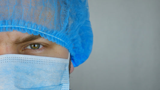 a close up of a person wearing a surgical mask