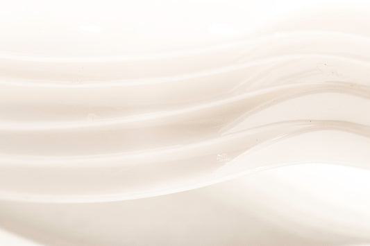 a close up of a white bowl with wavy lines