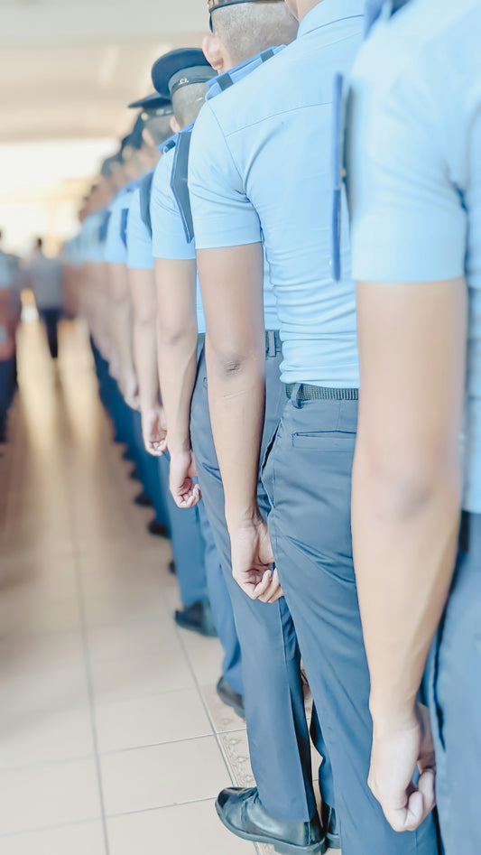 a row of uniformed men standing next to each other