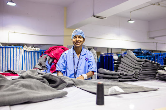 Worker smiles in textile factory.